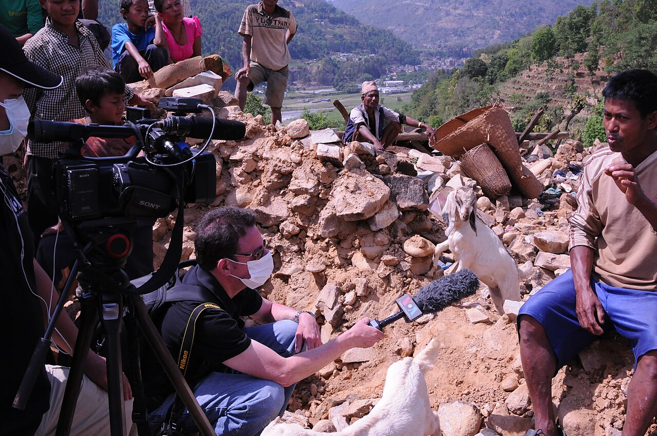 Villager amid rubble of collapsed stone homes after a Nepal earthquake